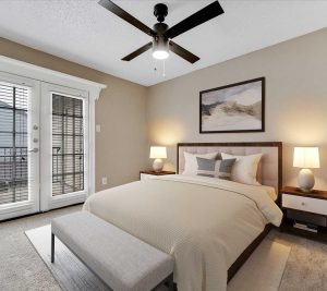 a bedroom with a ceiling fan and a bed at The Westmount at River Park