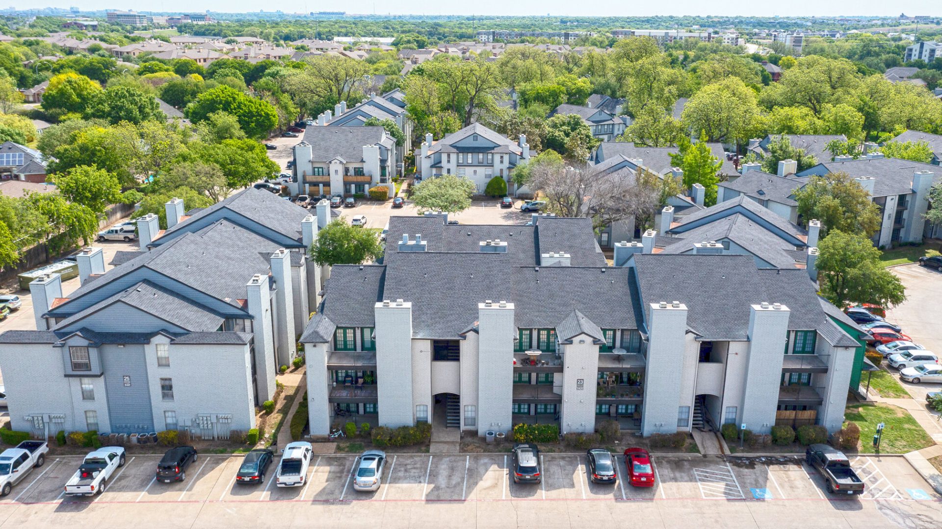 an aerial view of a residential complex with parking lots at The Westmount at River Park